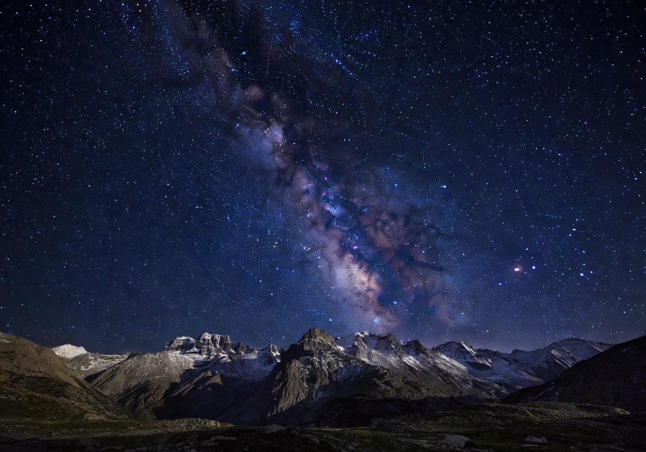 Starry night sky over mountains